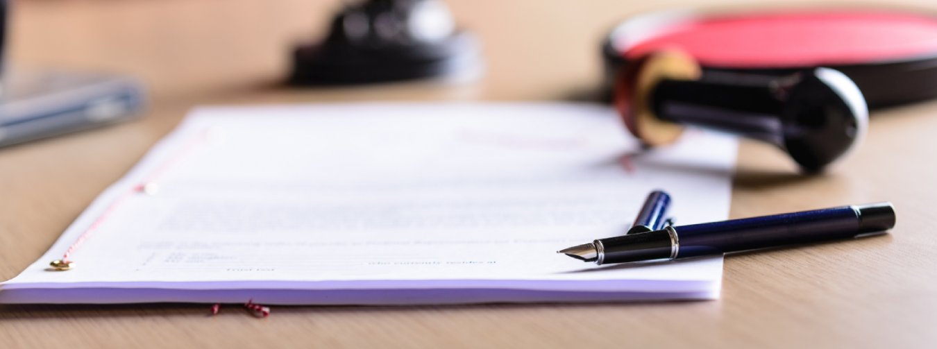 Contract Waiting For A Notary Public Sign On Desk.