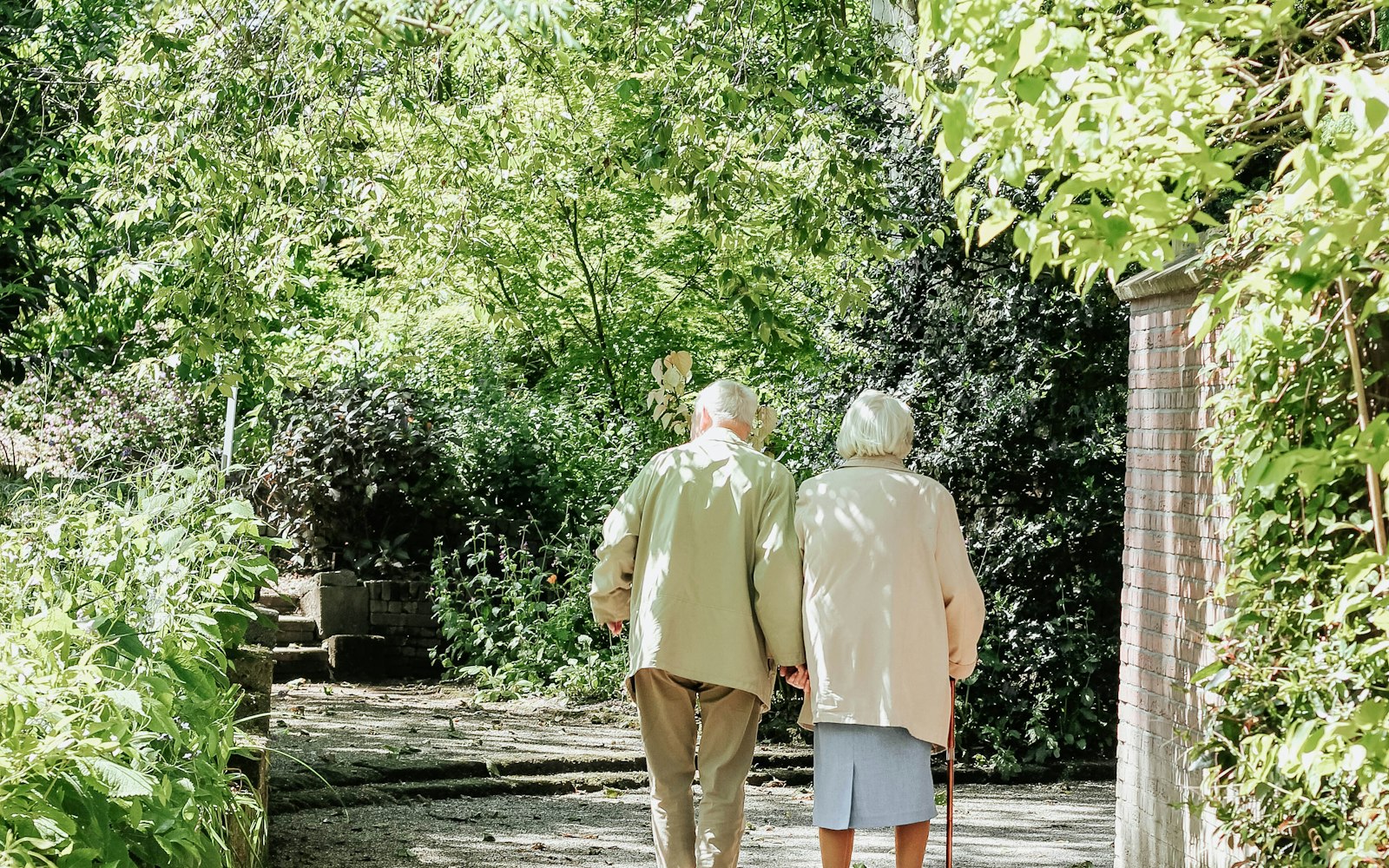 Retirement village exit entitlements Elderly couple walking along a garden path